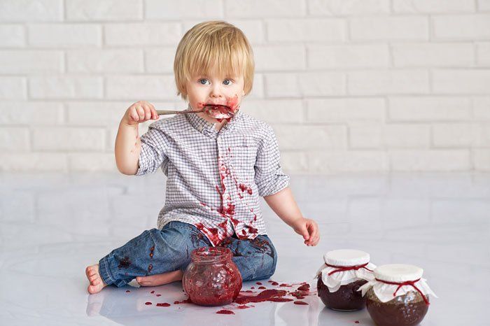 this kid can't stop eating strawberry jam